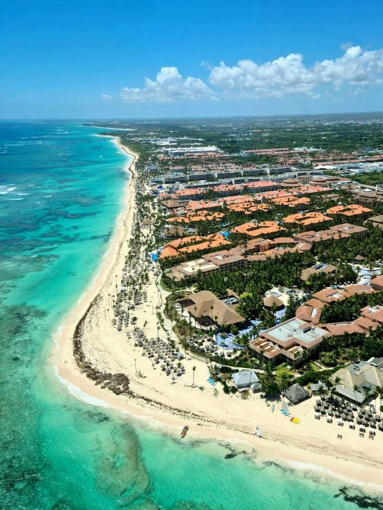 Breathtaking aerial view of Punta Cana's turquoise coast and resort-lined shoreline.