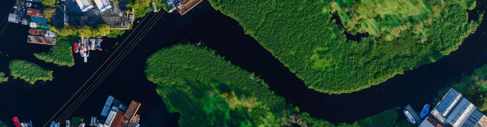 Stunning aerial shot of Glória neighborhood in Manaus, Brazil, featuring winding river and lush greenery.